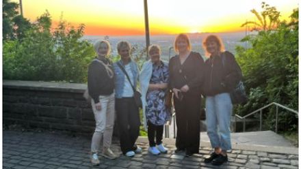 teachers in front of a sunset