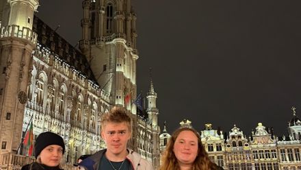 kids at night in front of old building with lights